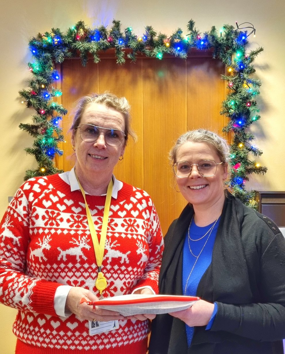 Þórgunnur Reykjalín skólastjóri (t.v.) færir Sólveigu Höllu presti (t.h.) framlag nemenda og starfsf…